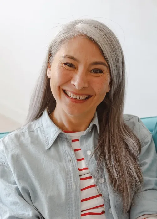 joyful-woman-with-smartphone-resting-on-couch-at-h